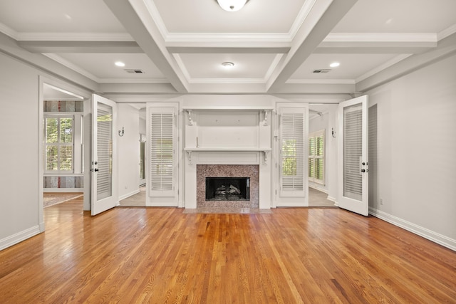 unfurnished living room featuring light wood-style flooring, baseboards, a fireplace, beam ceiling, and coffered ceiling