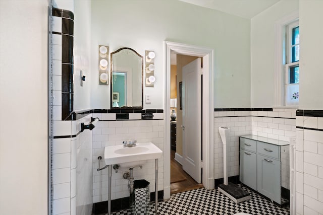 14 Morningside Pl, Memphis, TN 38104 - bathroom with tile walls, wainscoting, tile patterned floors, and a sink