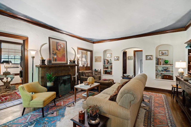 14 Morningside Pl, Memphis, TN 38104 - living area featuring arched walkways, ornamental molding, a fireplace, wood finished floors, and built in features