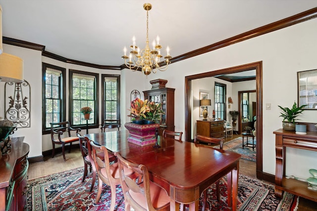 14 Morningside Pl, Memphis, TN 38104 - dining area with a chandelier, plenty of natural light, baseboards, wood finished floors, and ornamental molding