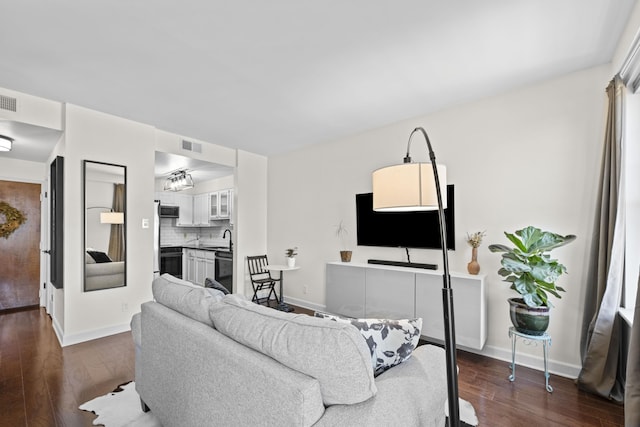 living area featuring baseboards and dark wood-style flooring