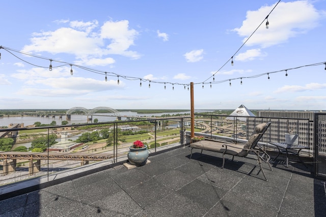 view of patio / terrace with a water view and a balcony