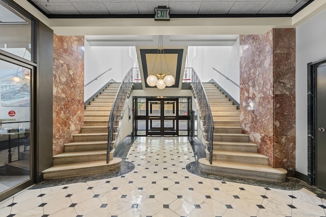 foyer entrance featuring stairs and a chandelier