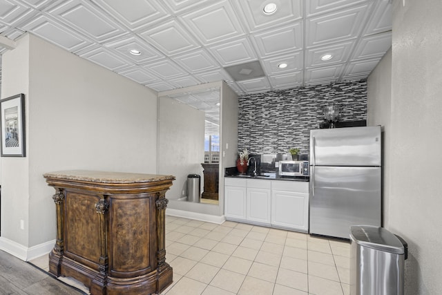 kitchen featuring appliances with stainless steel finishes, dark countertops, a sink, an ornate ceiling, and recessed lighting