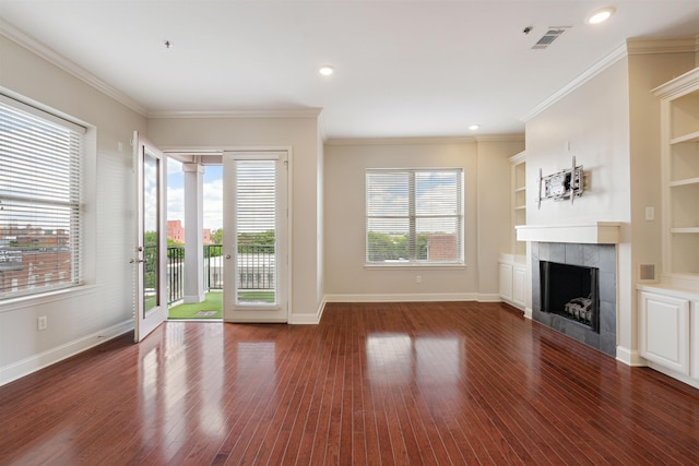 510 Cityhouse Ct Unit 406, Memphis, TN 38103 - unfurnished living room featuring a tile fireplace, hardwood / wood-style flooring, baseboards, crown molding, and recessed lighting