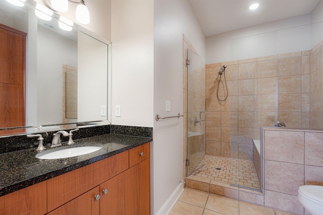 510 Cityhouse Ct Unit 406, Memphis, TN 38103 - bathroom featuring a shower stall, tile patterned floors, vanity, toilet, and baseboards