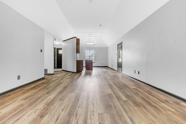 unfurnished living room with wood finished floors and baseboards