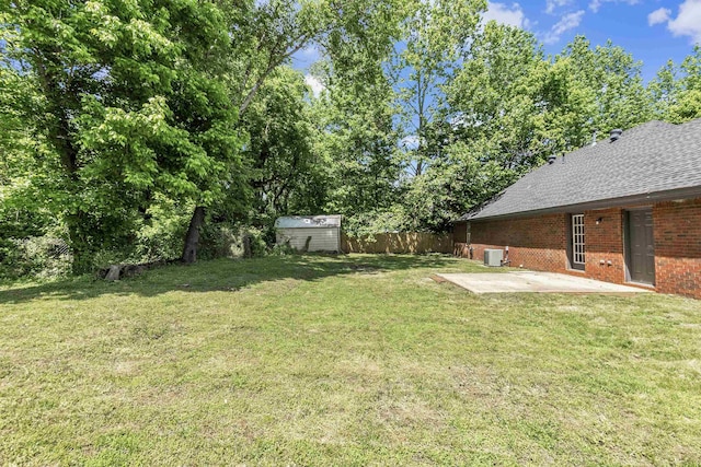 view of yard with a patio area, a storage shed, and an outdoor structure