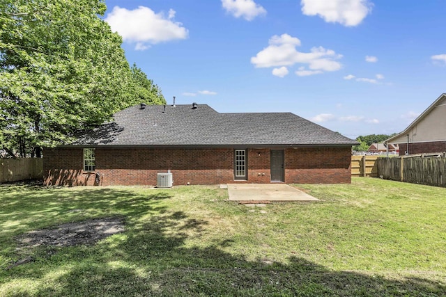 back of house with brick siding, a patio, roof with shingles, and cooling unit