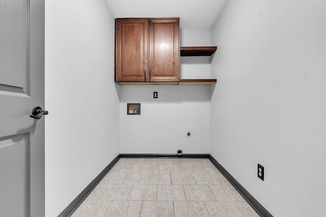 laundry area featuring hookup for a washing machine, cabinet space, electric dryer hookup, and baseboards