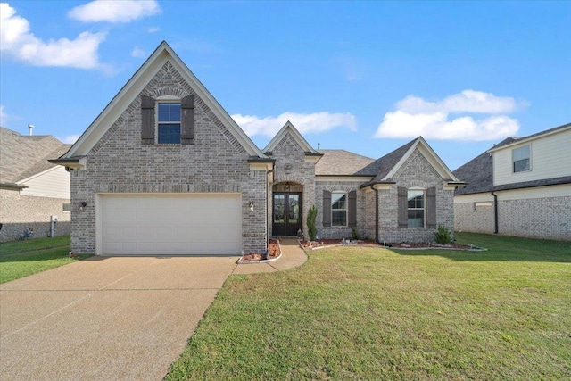 40 Chesnut Spring Dr, Oakland, TN 38060 - french country style house with brick siding, driveway, and a front lawn