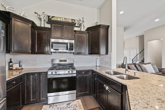 40 Chesnut Spring Dr, Oakland, TN 38060 - kitchen with stainless steel appliances, a sink, dark wood-type flooring, light stone countertops, and recessed lighting