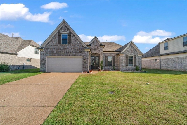 40 Chesnut Spring Dr, Oakland, TN 38060 - view of front facade with a garage, concrete driveway, brick siding, and a front yard