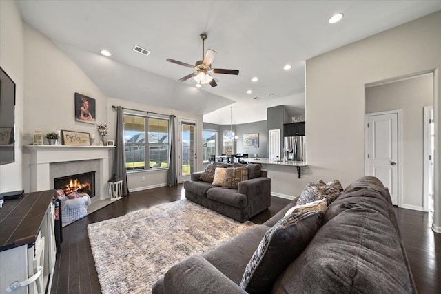 40 Chesnut Spring Dr, Oakland, TN 38060 - living room featuring ceiling fan, vaulted ceiling, a fireplace with flush hearth, dark wood-type flooring, and baseboards