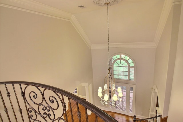 detailed view of a chandelier, french doors, and ornamental molding