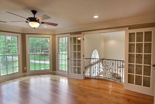 unfurnished room with ornamental molding, a ceiling fan, and wood finished floors