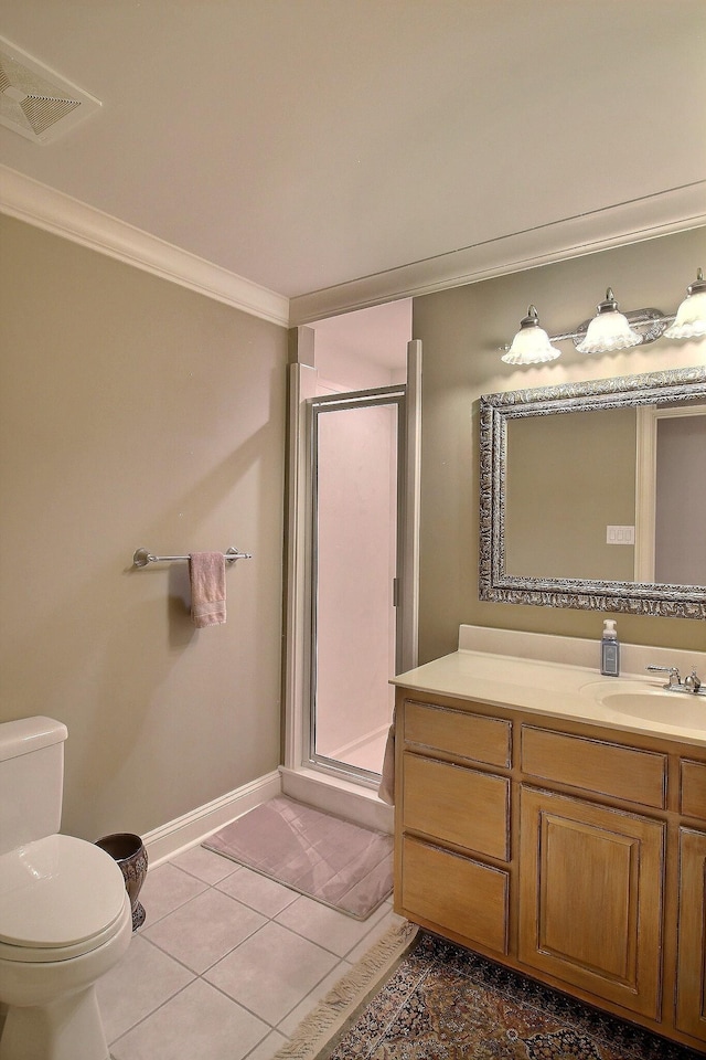 bathroom featuring crown molding, a stall shower, toilet, vanity, and baseboards