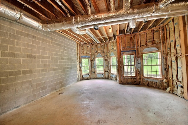 miscellaneous room featuring unfinished concrete flooring and healthy amount of natural light