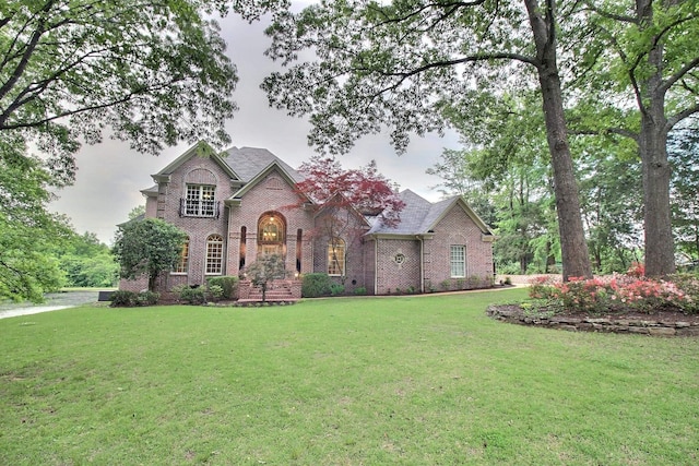 view of front of house with brick siding and a front yard