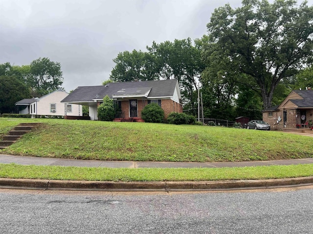 ranch-style home with brick siding and a front lawn