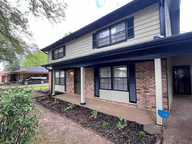 2902 Capri St, Memphis, TN 38118 - view of side of property featuring brick siding and a porch
