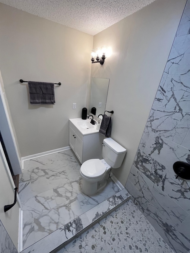 2902 Capri St, Memphis, TN 38118 - bathroom featuring marble look tiles, a textured ceiling, vanity, toilet, and baseboards