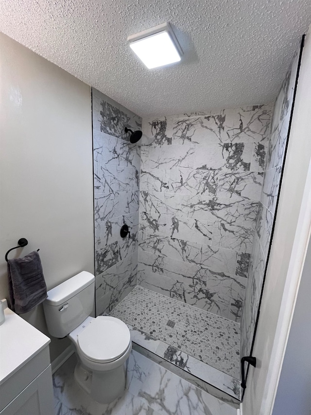 2902 Capri St, Memphis, TN 38118 - bathroom with a textured ceiling, a stall shower, toilet, marble finish flooring, and vanity