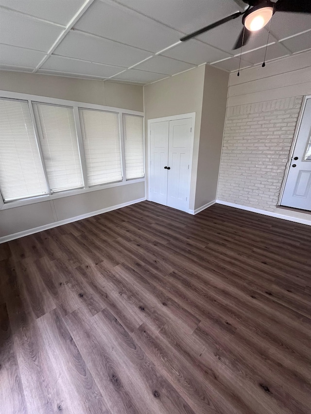 2902 Capri St, Memphis, TN 38118 - empty room with baseboards, brick wall, wood finished floors, and a ceiling fan
