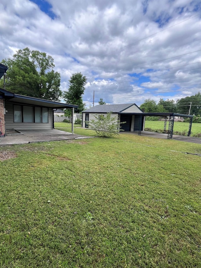2902 Capri St, Memphis, TN 38118 - view of grassy yard featuring an attached carport and driveway