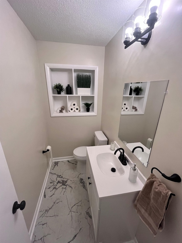 2902 Capri St, Memphis, TN 38118 - half bath featuring marble look tiles, a chandelier, toilet, a textured ceiling, and baseboards