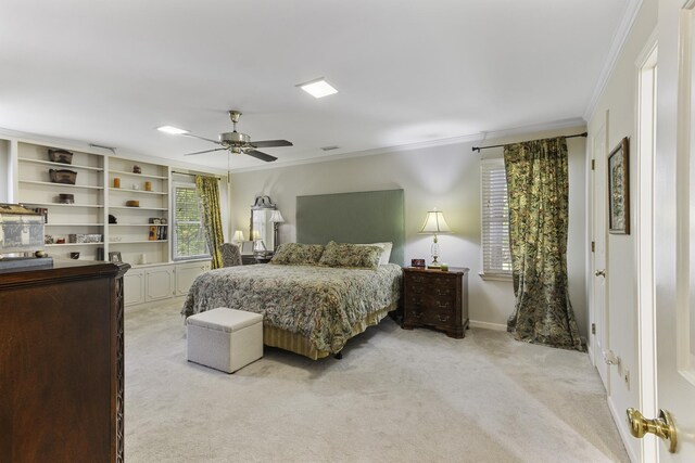 bedroom with light colored carpet, ornamental molding, a ceiling fan, and baseboards