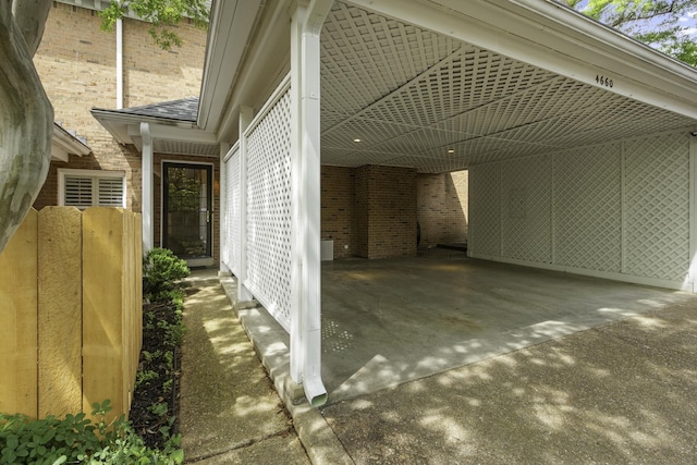 view of home's exterior with brick siding and a carport