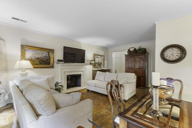 living room featuring crown molding and a fireplace
