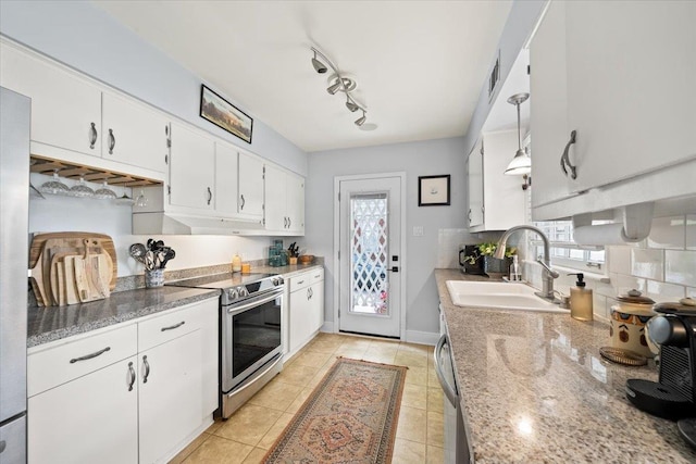 kitchen featuring stainless steel electric stove, a sink, white cabinets, backsplash, and light tile patterned flooring