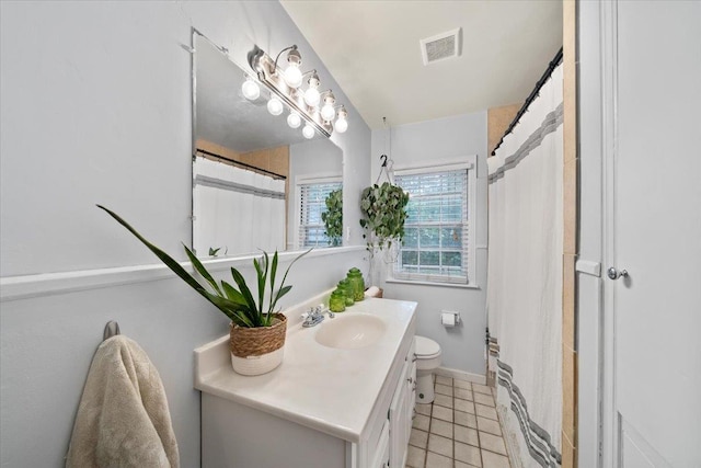 full bathroom featuring vanity, toilet, tile patterned flooring, and baseboards