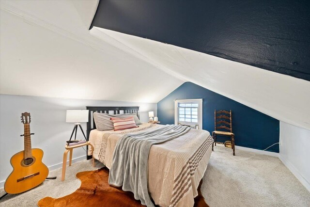 bedroom featuring carpet floors, vaulted ceiling, and baseboards