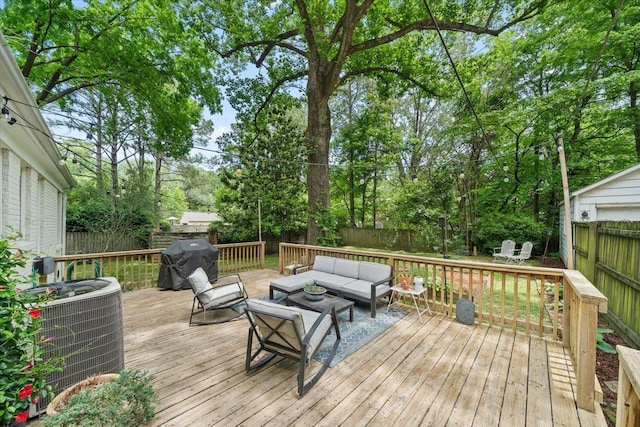 wooden terrace with an outdoor living space, cooling unit, a fenced backyard, and a grill