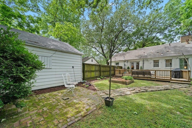 view of yard featuring a wooden deck and a patio area
