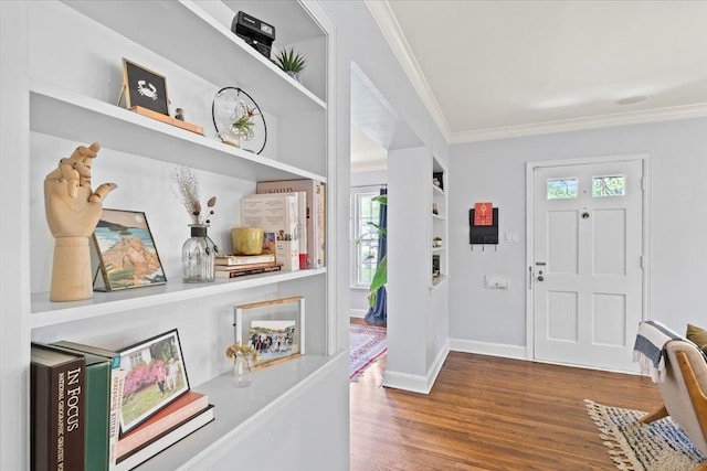 entryway featuring ornamental molding, wood finished floors, and baseboards