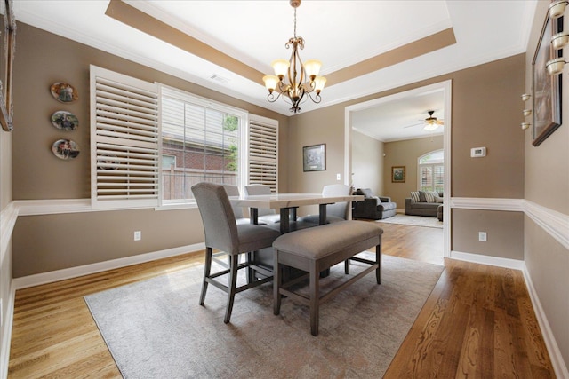 1685 Jennings Mill Ln, Collierville, TN 38017 - dining space featuring ornamental molding, healthy amount of natural light, a chandelier, wood finished floors, and a tray ceiling