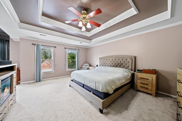 8606 Meadow Green Dr, Memphis, TN 38016 - bedroom featuring a tray ceiling, light colored carpet, ornamental molding, baseboards, and ceiling fan