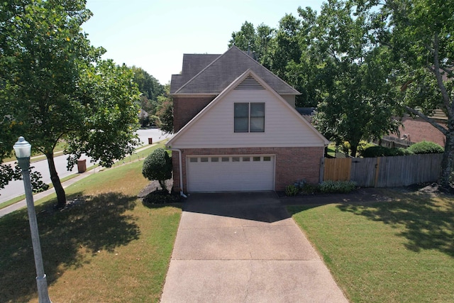 8606 Meadow Green Dr, Memphis, TN 38016 - traditional home with brick siding, driveway, and a garage