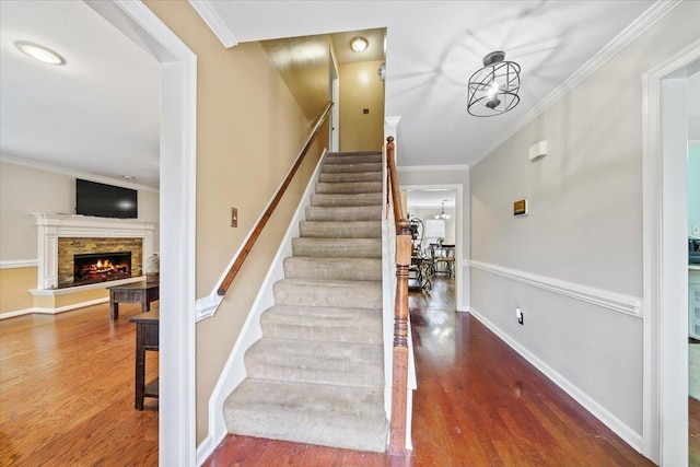 8606 Meadow Green Dr, Memphis, TN 38016 - stairs with wood finished floors, ornamental molding, a fireplace, and baseboards