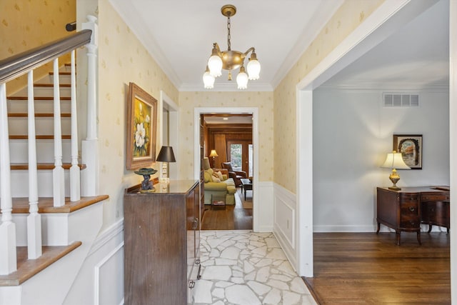 5532 Gwynne Rd, Memphis, TN 38120 - entrance foyer with wallpapered walls, light wood finished floors, a chandelier, stairway, and ornamental molding