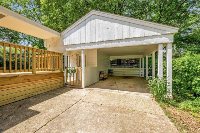 view of patio / terrace with driveway and a carport