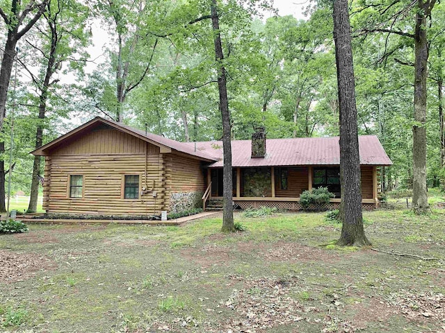 4560 Bishop Rd, Middleton, TN 38052 - cabin featuring log exterior, a chimney, and covered porch