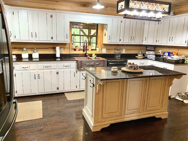 4560 Bishop Rd, Middleton, TN 38052 - kitchen with fridge with ice dispenser, a center island, dark wood-style floors, and white cabinets