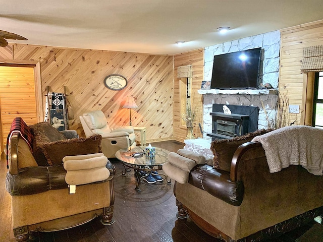 4560 Bishop Rd, Middleton, TN 38052 - living area with wooden walls, hardwood / wood-style flooring, a stone fireplace, and ceiling fan