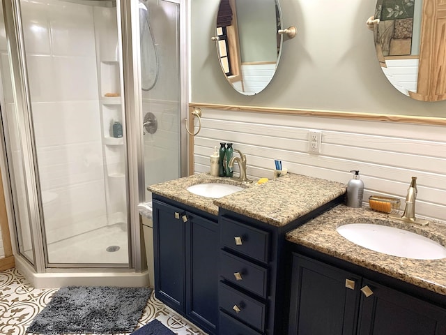 4560 Bishop Rd, Middleton, TN 38052 - full bathroom featuring a stall shower, double vanity, and wainscoting