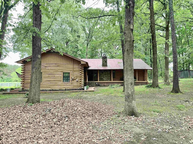 4560 Bishop Rd, Middleton, TN 38052 - view of front of property featuring log exterior, a chimney, and a porch